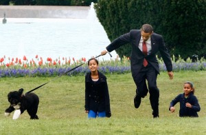 President Obama playing with daughters and new dog Bo