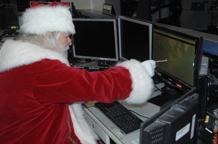 Santa-Inspecting-Santa Cams at NORAD-Santa Tracker headquarters
