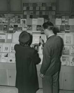 A couple looks at Infant Care pamphlet at GPO Bookstore: GPO Archives. 