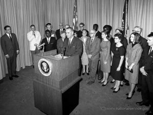 President Lyndon B. Johnson and Vista volunteers. Image courtesy of nationalservice.gov 